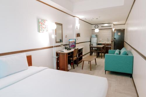 a hotel room with a bed and a dining room at Toyoko Inn Cebu in Cebu City