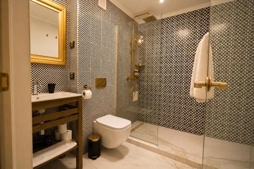 a bathroom with a toilet and a shower and a sink at The Square Hotel in Cluj-Napoca