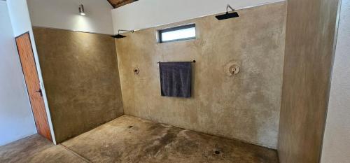 an empty room with a window on the wall at Pata Pata House in Marloth Park