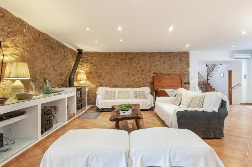 a living room with two beds and a couch at Casa Horta Den Menut in Pollença