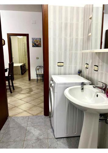 a bathroom with a sink and a washing machine at Grace's Blue corner in Marconia