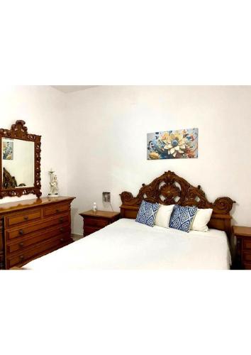 a bedroom with a large bed and a mirror at Grace's Blue corner in Marconia
