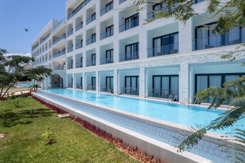an empty swimming pool in front of a building at Tembo Kiwengwa Resort in Kiwengwa