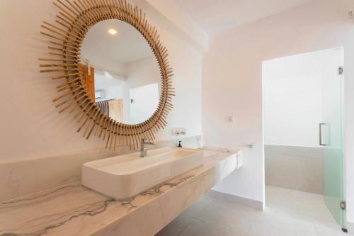 a bathroom with a sink and a mirror at The One Resort in Koh Rong Island