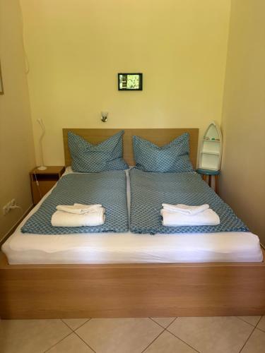 a bedroom with a bed with two towels on it at Delfin Apartman Balatonfüred in Balatonfüred