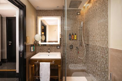 a bathroom with a sink and a shower at The Venice Times Hotel, Vignette Collection by IHG in Venice