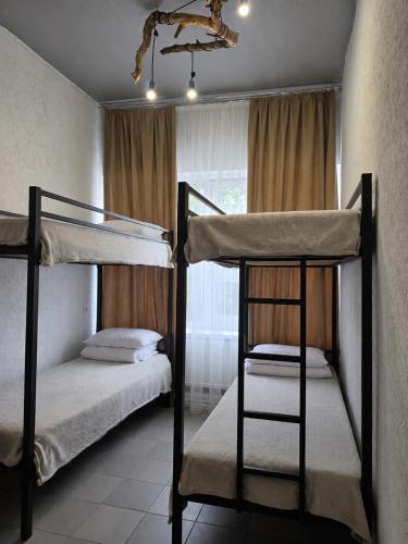 two bunk beds in a room with a window at Хостел Арабея in Vinnytsya