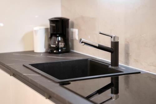 a kitchen sink with a faucet on a counter at Casa Sole Porlezza in Porlezza