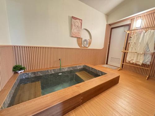 a large bath tub in a room with a wooden floor at ดูดาวแคมป์ริมโขง in Chiang Khan