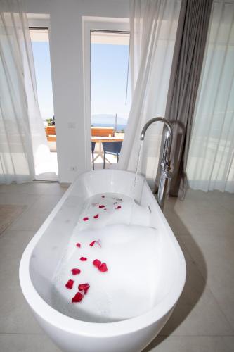 a bathroom with a bath tub with red hearts in it at Novaeos Sicily in Terrasini