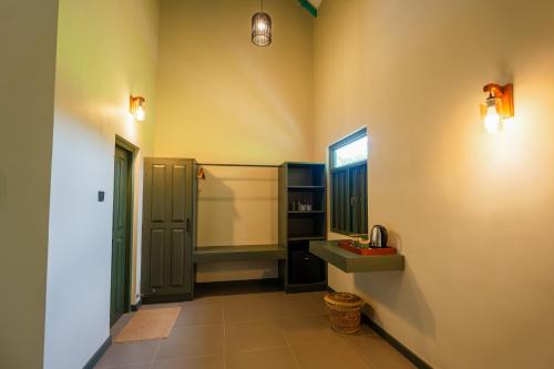 a bathroom with a sink and a mirror at Cape Sigiriya in Sigiriya