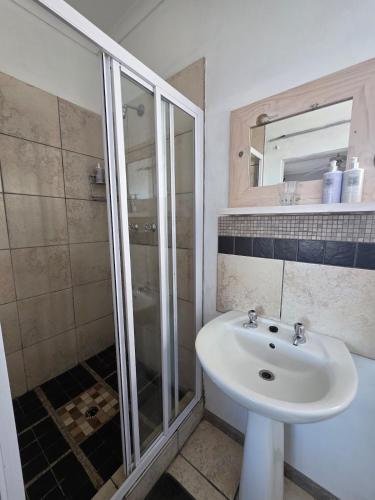 a bathroom with a sink and a shower at Deck Room with Neighborhood view in Bunkers Hill