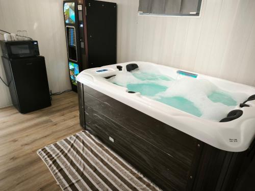 a jacuzzi tub in a room with a television at Suite DT4 in Blotzheim