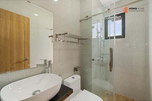 a bathroom with a toilet and a sink and a shower at HongHome Nguyễn Cửu Vân in Ho Chi Minh City