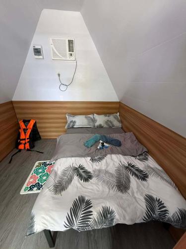 a bed in a small room with avertisementatronatronatron at Fresh Beach Resort in Cateel