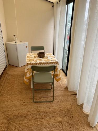 a table and two chairs with a table and a table and a table at Maison Teiss in Aigues-Mortes