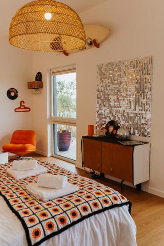 a bedroom with a large bed and a window at Les Ecuries du bout du monde in Landunvez