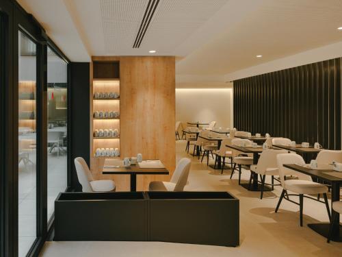a dining room with tables and chairs in a restaurant at Sercotel Valencia Ruzafa in Valencia