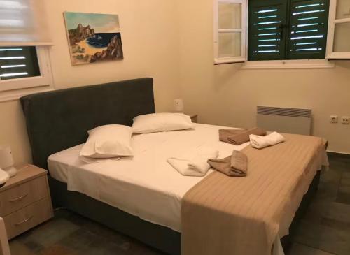 a bedroom with a large bed with white sheets and pillows at Luxury Maisonet Veranda View Batsi in Batsi