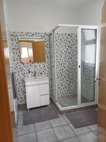 a bathroom with a shower and a sink at Madeira Pura in Calheta