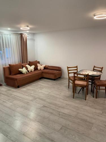 a living room with a couch and a table at Lad Petite Maison in Craiova