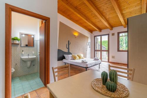 a living room with a table and a bathroom at Pathos Retreat Pool and Garden in Syracuse
