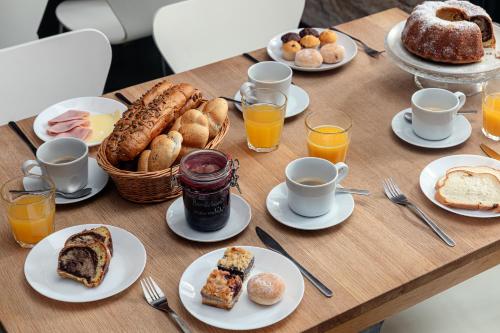 a table topped with plates of breakfast foods and drinks at Zámecký Hostel Litomyšl in Litomyšl