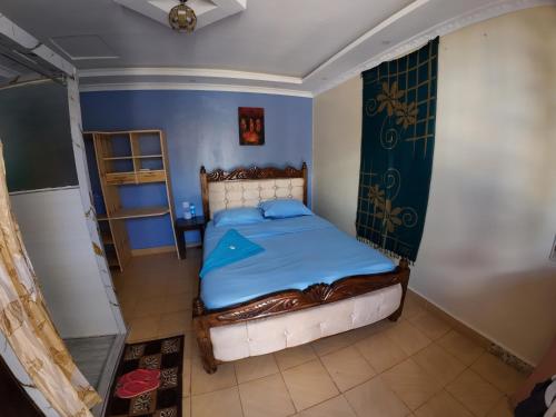 a small bedroom with a bed in a room at jc iten in Iten