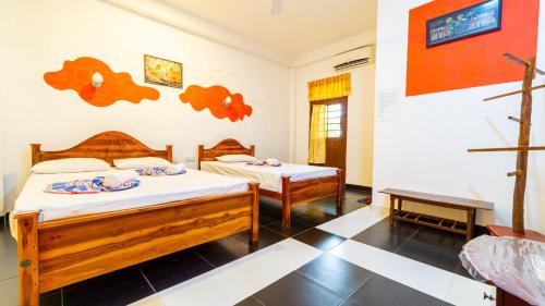 a bedroom with two beds in a room at N S K Green Villa in Sigiriya