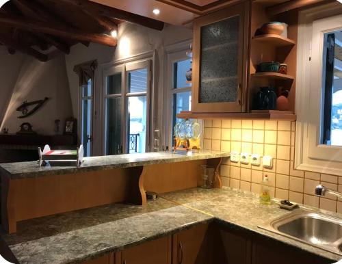a kitchen with a sink and a counter top at Luxury Maisonet Veranda View Batsi in Batsi