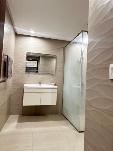 a bathroom with a sink and a shower at The Cubee Nest- Luxury 1BHK in Central Bahria Enclave in Islamabad