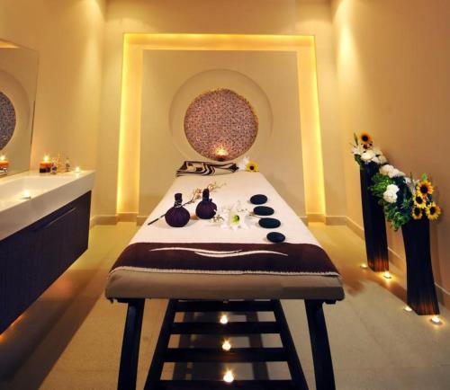 a spa room with a massage table and a sink at Tropitel Sahl Hasheesh in Hurghada