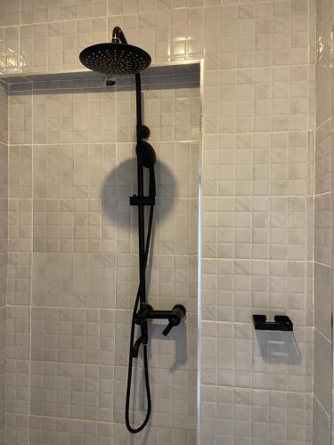 a shower with a shower head in a bathroom at Sky Beach Resort in Kisumu