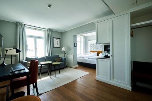 a living room with a couch and a bed and a table at Hotel Halm Konstanz in Konstanz