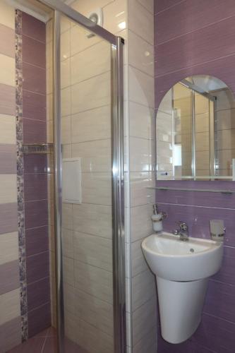 a bathroom with a sink and a shower at Golden Sea View Penthouse in Pomorie