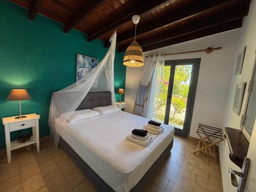 a bedroom with a bed with a mosquito net at Villas Vista Del Mar in Kissamos