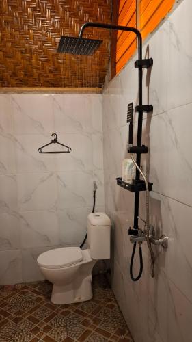 a bathroom with a toilet and a shower at Bamboo Craft Homestay in Sangyang