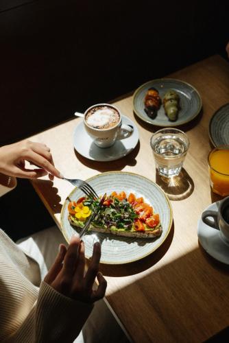a person sitting at a table with a plate of food at Atipico Madrid in Madrid