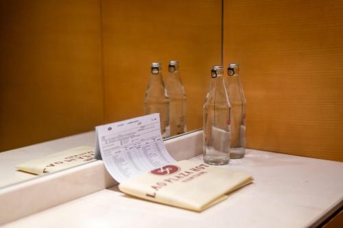 two empty bottles sitting on a counter in a bathroom at Lao Plaza Hotel in Vientiane