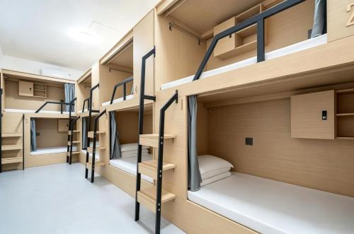 a row of bunk beds in a dorm room at Passerby hostel samui in Nathon Bay