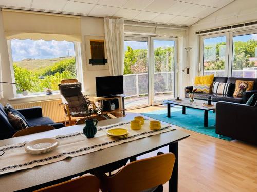 a living room with a couch and a table at De Strandloper in Julianadorp