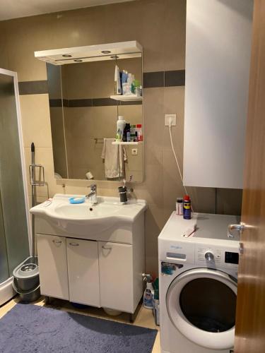 a bathroom with a sink and a washing machine at Eva in Pržno