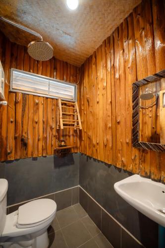 a bathroom with a toilet and a sink at Phupai Lake Resort in Ban Wang Khun Knachen