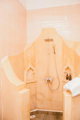 a bathroom with a shower in the corner at Sea View Lodge Boutique Hotel in Jambiani