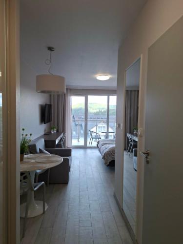 a living room with a couch and a table at Apartament Bormio MarsMed in Biała Woda