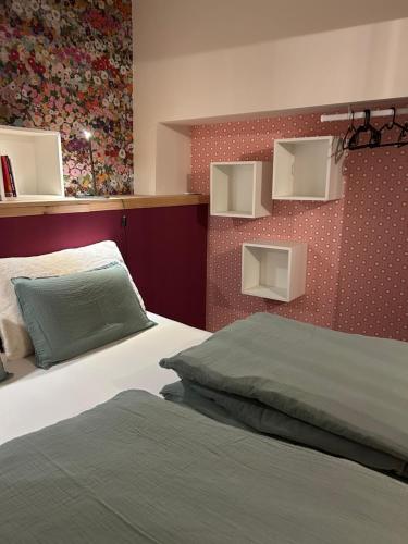 a bedroom with two beds and a wall with shelves at Chez Gaston in Spa