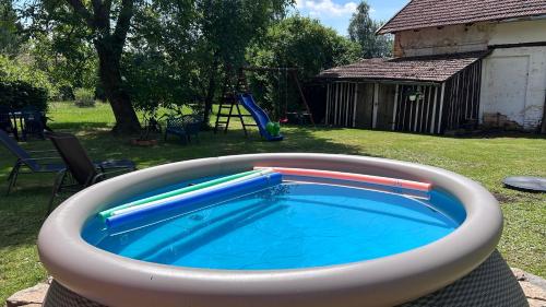 a swimming pool with inflatable tubes in a backyard at Apartmán Bystré in Bystré
