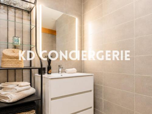 a bathroom with a sink and a mirror at L'ESCAPADE MARINE - face à la Mer in Port-de-Bouc