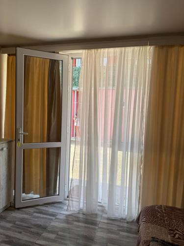 a bedroom with a sliding glass door to a patio at Hotel barbie Cottage #1-2 in Ureki
