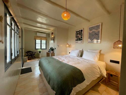 a bedroom with a large bed in a room at Dar Serenia Rohuna in Rehouna